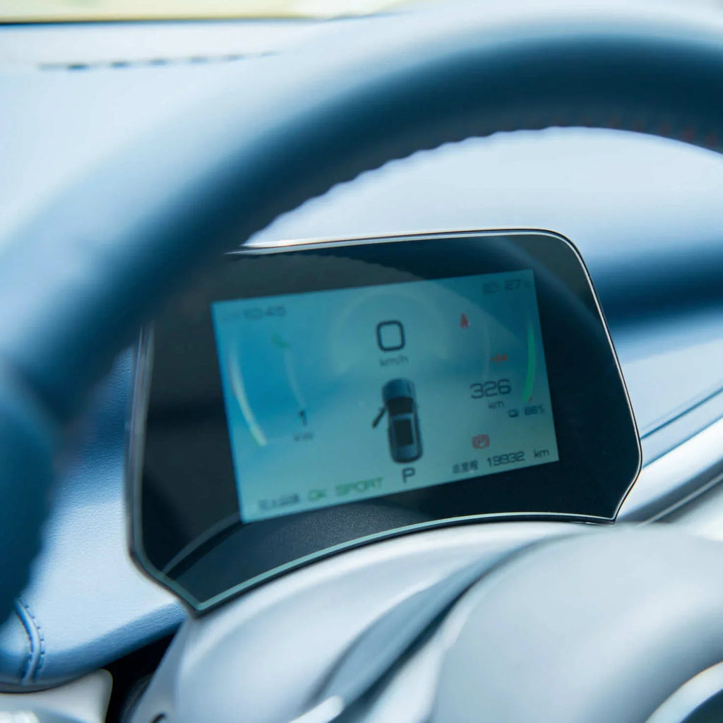 Digital blue car dashboard display showing speed, range, and vehicle status on a modern instrument cluster.