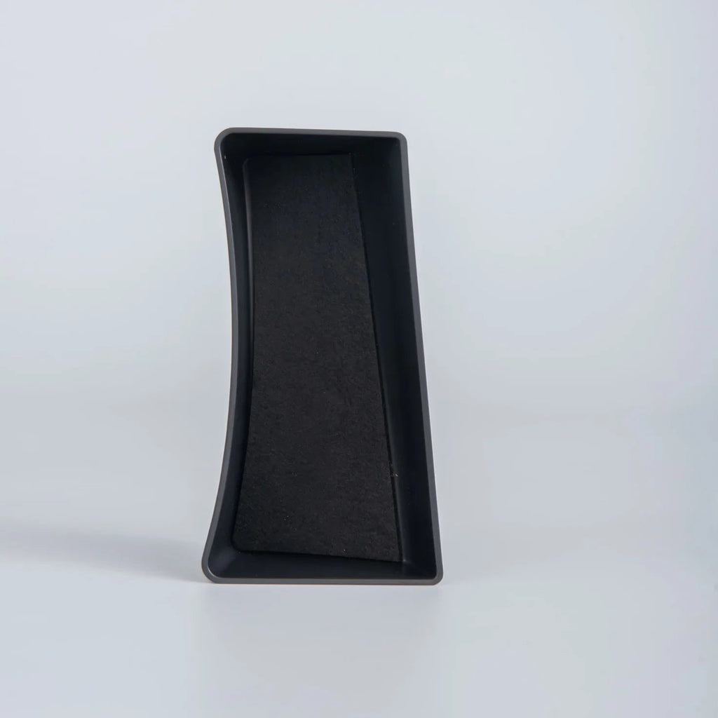 Black textured non-slip tray liner made of durable composite material for car interior protection.