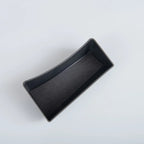 Curved black matte storage tray with a non-slip felt lining for car interior organization.