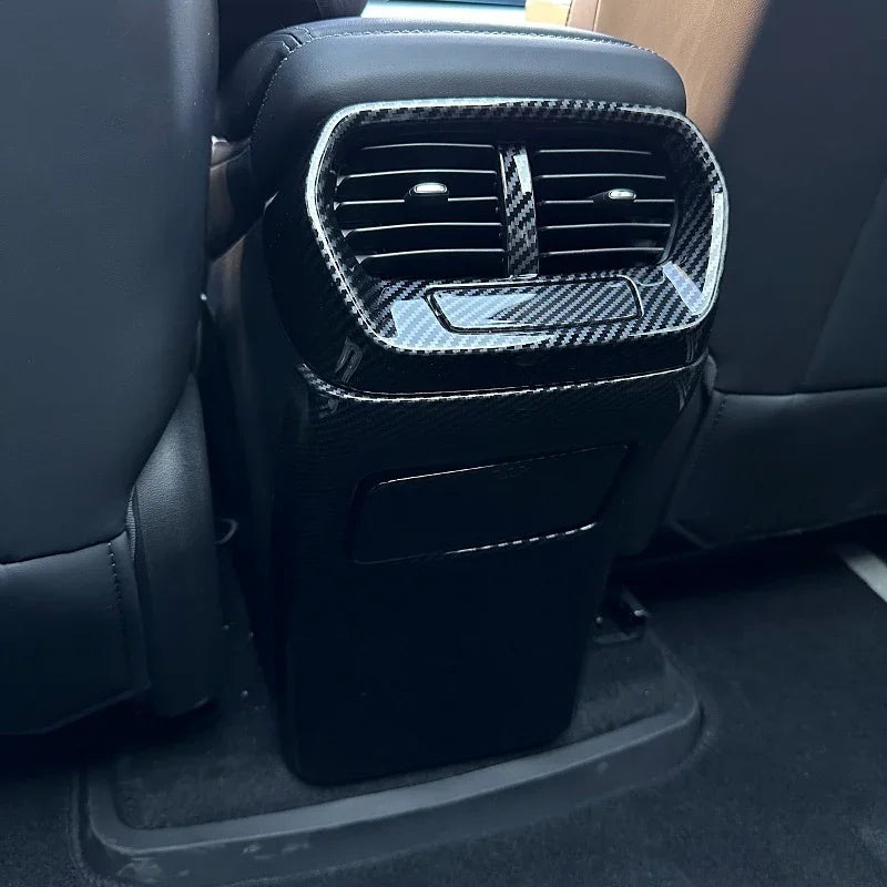 Black carbon fiber pattern rear air vent cover for BYD car interior protection.