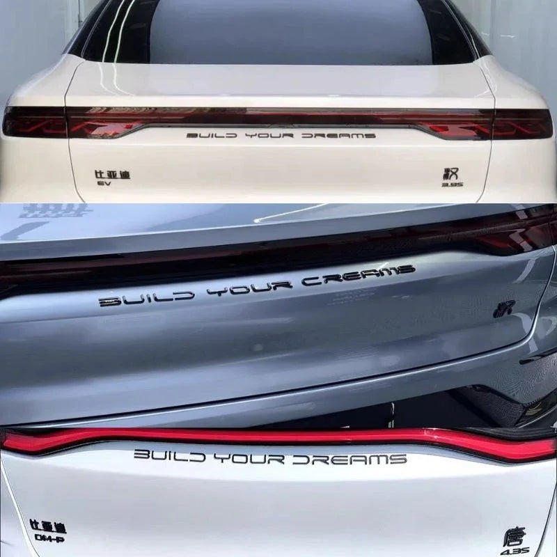 Chrome silver Build Your Dreams lettering emblem for BYD vehicle rear trunk decoration.