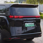 Rear view of a sleek black BYD Denza MPV featuring distinctive red LED taillights.