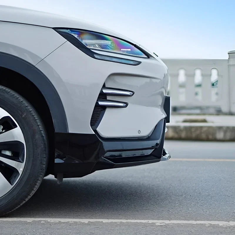White BYD front bumper with sleek black aerodynamic side skirts and protective trim.