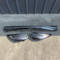Glossy carbon fiber pattern door sill protector plates in black and dark grey.