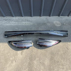 Glossy carbon fiber pattern door sill protector plates in black and dark grey.