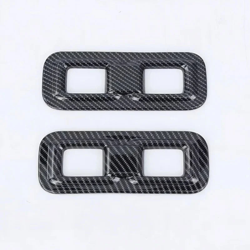 Two carbon fiber textured grey aftermarket car interior trim covers