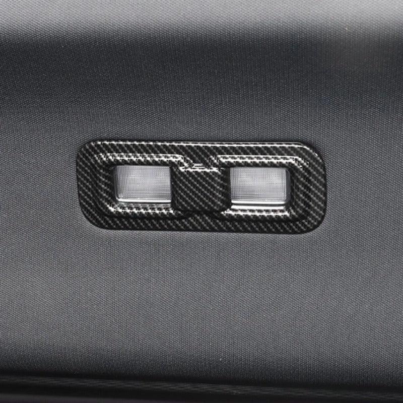 Carbon fiber texture window switch panel in sleek black for car interior enhancement.