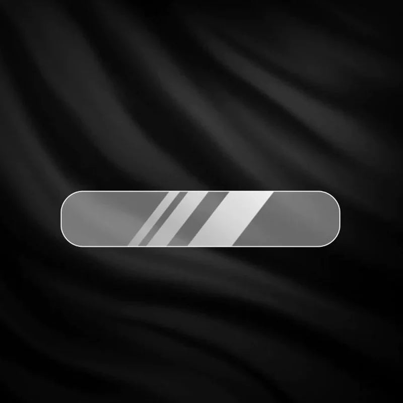 Sleek silver metallic trim accessory with diagonal textured stripes on a black fabric background.