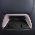 Cute cat-themed black seatbelt buckle covers on a grey car seat interior.