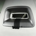 Black matte plastic grab handle hook accessory installed on a light grey car interior trim.