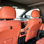 Premium orange leather car seat upholstery with high-quality stitching and ergonomic design.