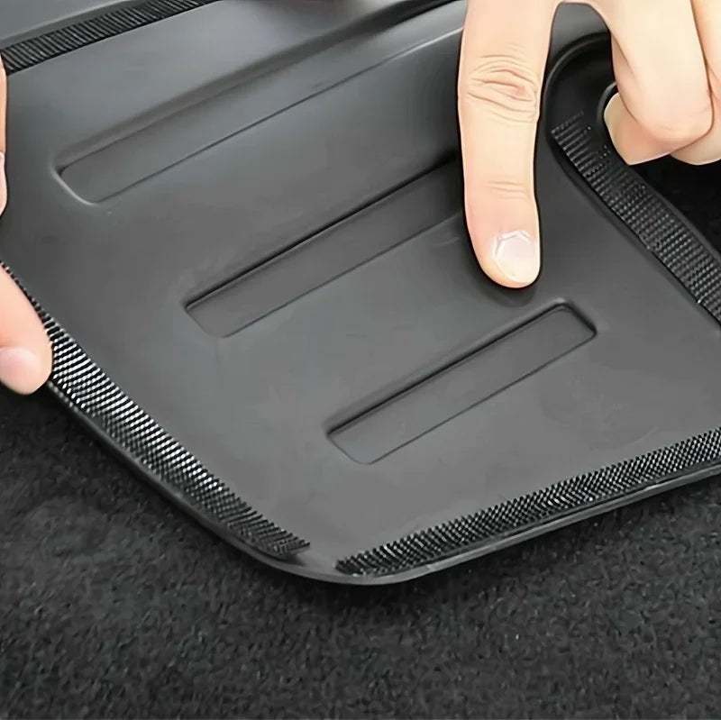 Black waterproof TPE car floor mat with textured anti-slip edges and recessed grooves.