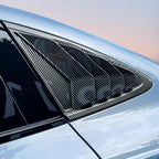 Black carbon fiber rear window louvers for car protection and aerodynamic styling.