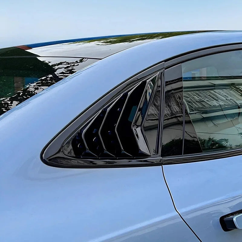 Glossy black aerodynamic window trim vent for car side windows.