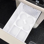 White plastic center console organizer tray with custom compartments for car interior