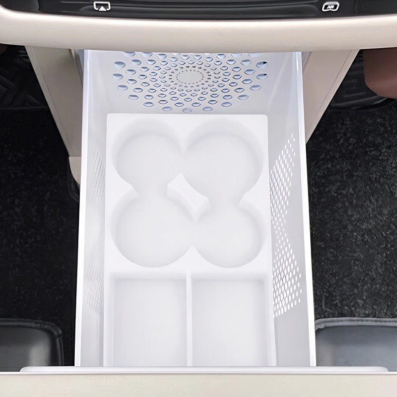 White plastic center console organizer tray with custom cup holders and storage compartments.