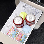 White durable plastic car center console organizer drawer holding drinks and snacks.
