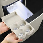 Beige premium organizer tray with textured surface and four circular compartments for car storage.
