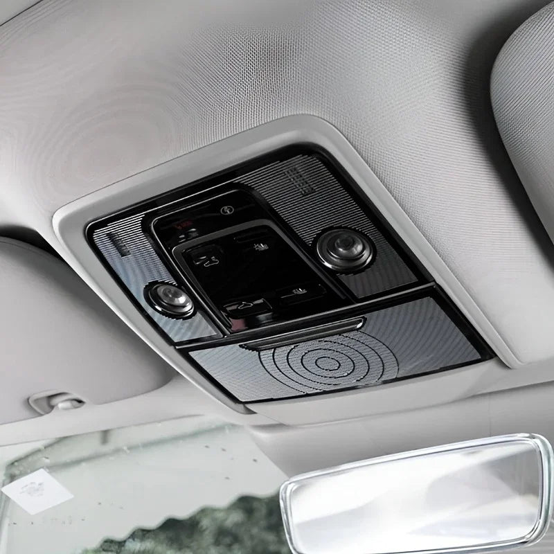 Black glossy interior overhead console with integrated LED lights and control buttons.