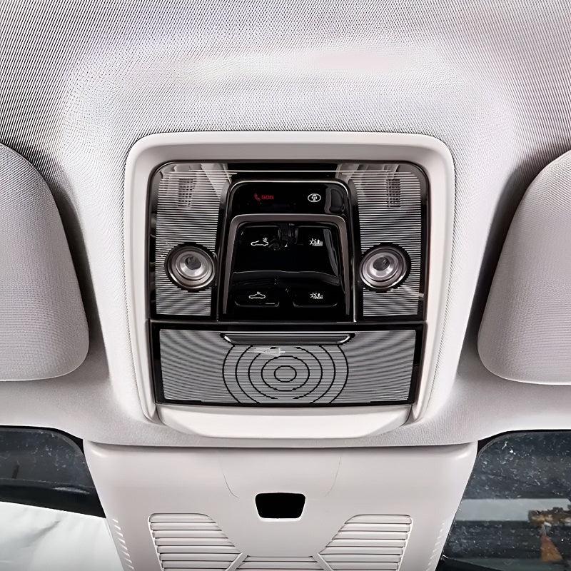Black gloss overhead console with integrated interior lights and sun visor controls.