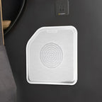 Silver metallic Dynaudio speaker grille with a circular perforated pattern on a dark interior panel.