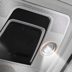 Silver metallic interior panel featuring a black control switch and a bright LED reading light.