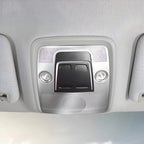 Close-up of a grey interior overhead console with integrated reading lights and sun visors.