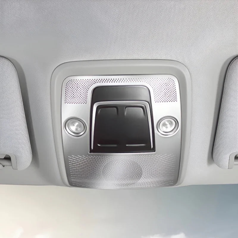 Close-up of a grey interior overhead console with integrated reading lights and sun visors.