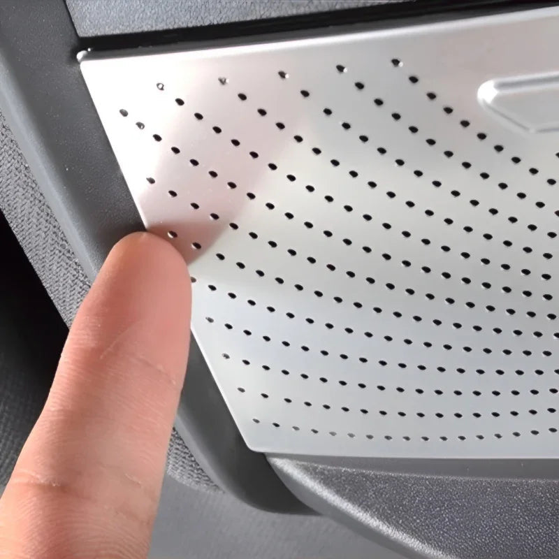 Silver perforated metal trim panel for car interior enhancement.