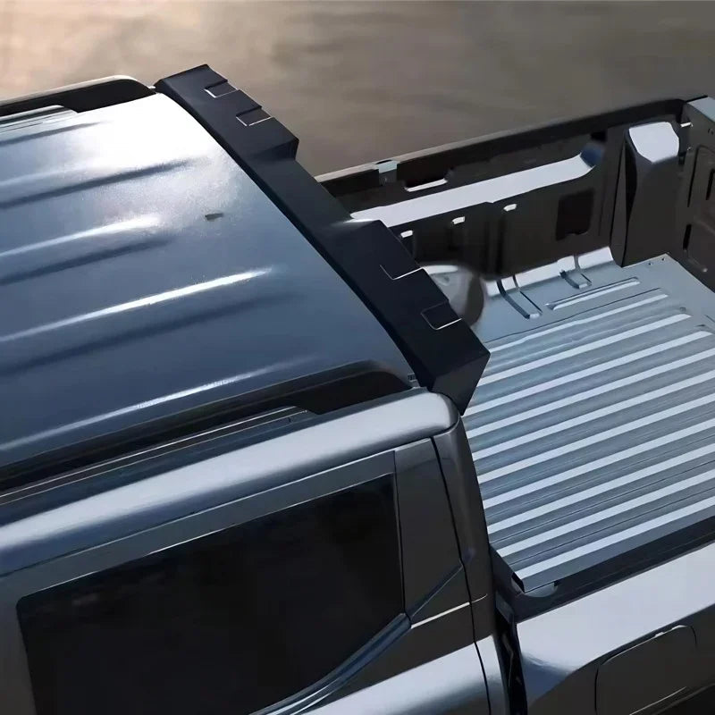 Black textured matte-finish bed rail protector installed on a silver pickup truck bed.