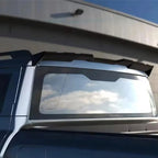Black matte rear spoiler installed on the back window of a silver SUV.