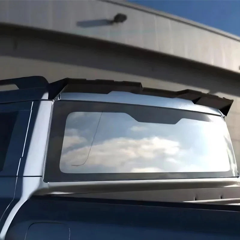 Black matte rear spoiler installed on the back window of a silver SUV.