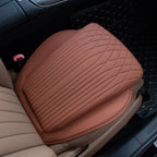 Brown perforated leather car seat cushion with diamond quilted stitching pattern.