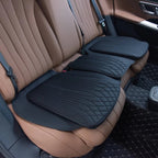 Black quilted leather car seat protectors installed on brown perforated leather interior seats.