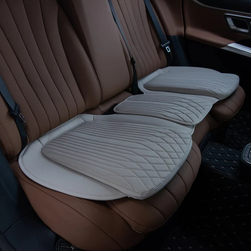 Perforated beige leather car seat covers with diamond quilted stitching on brown interior.