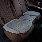 Perforated beige leather car seat covers with diamond quilted stitching on brown interior.