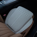 Light gray perforated leather car seat cover with diamond quilted stitching pattern.