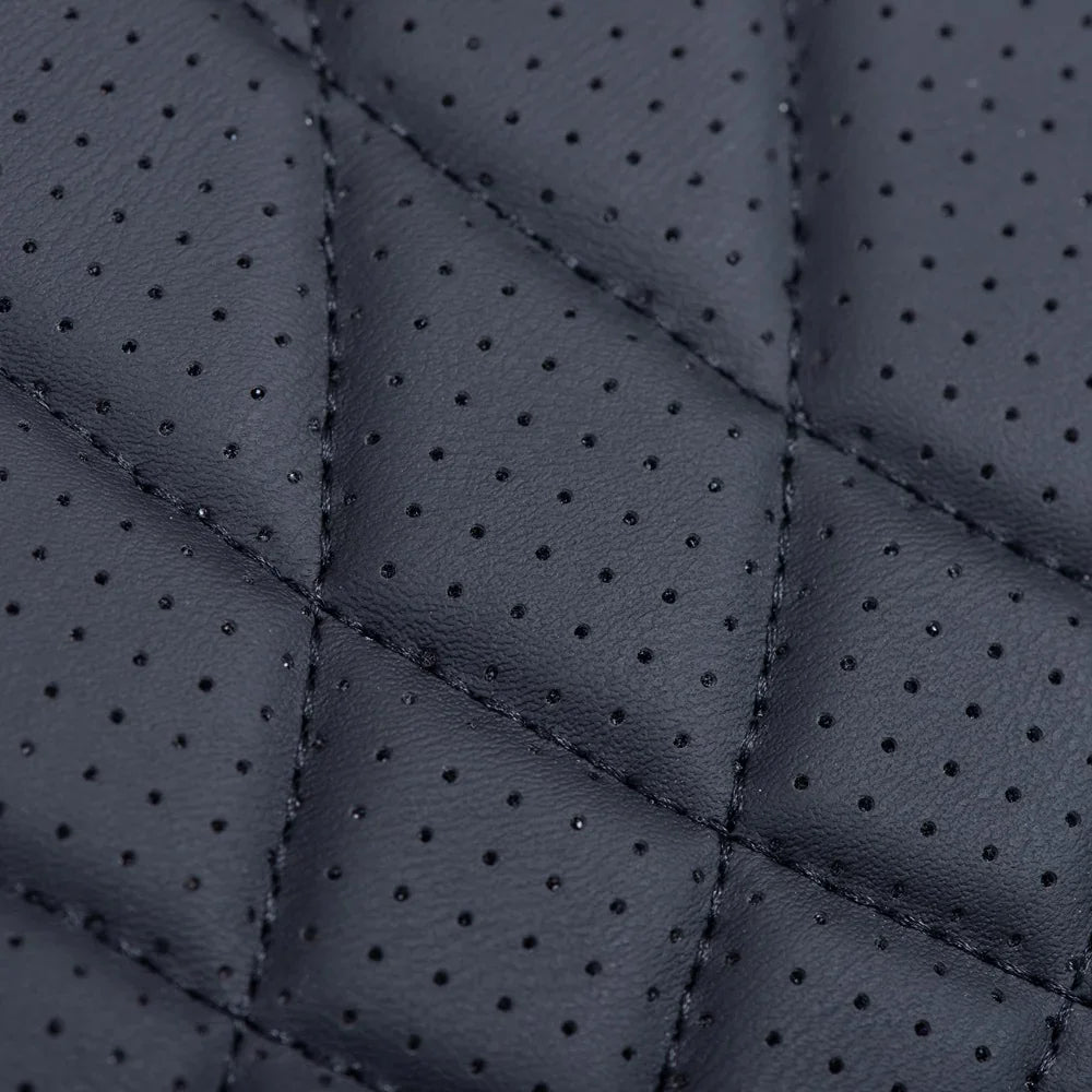 Black perforated leather with premium diamond-quilted stitching for luxury car interiors.