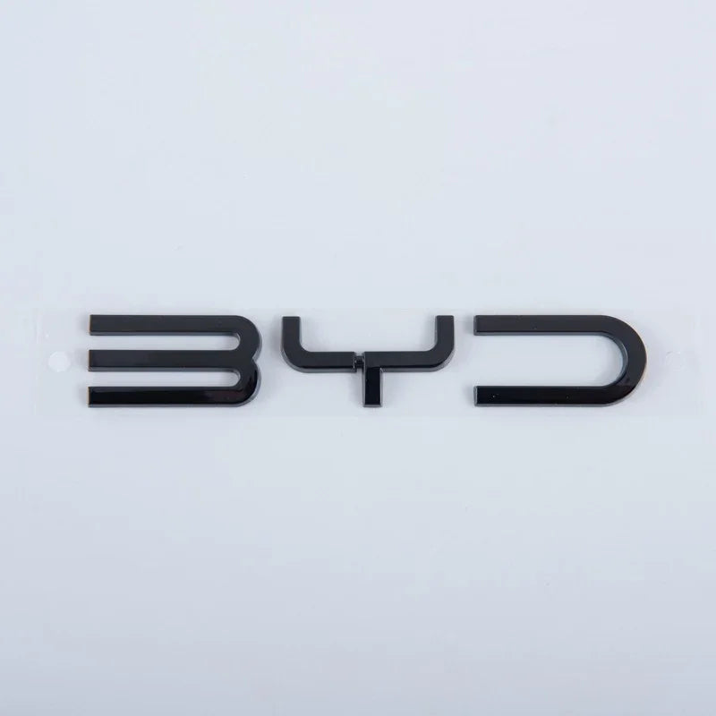 Glossy black 3D BYD emblem made of premium durable material on white background