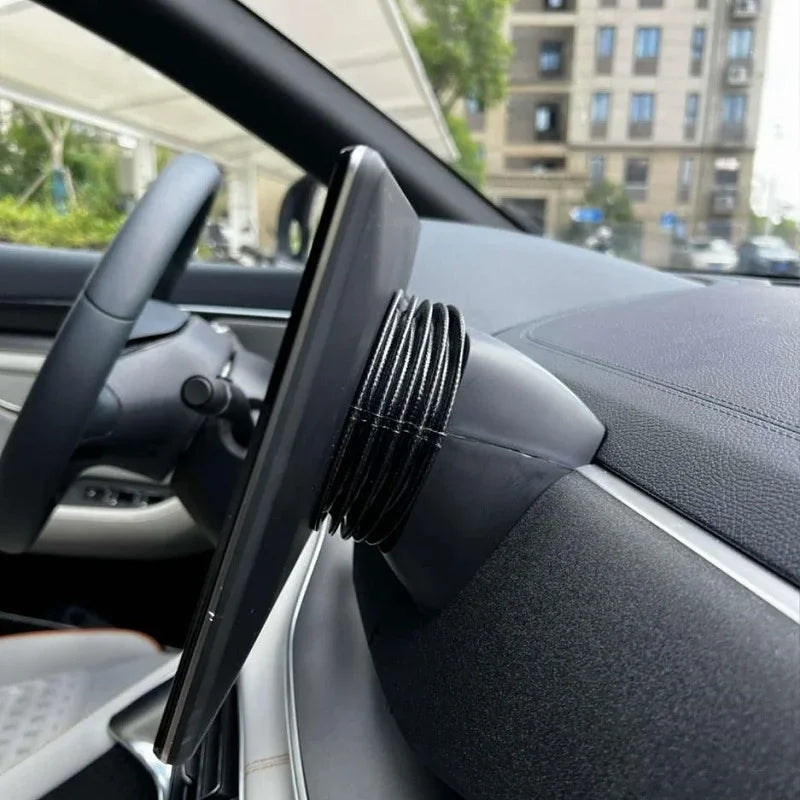 Close-up of a black leather-textured rotating mount for a car infotainment screen.