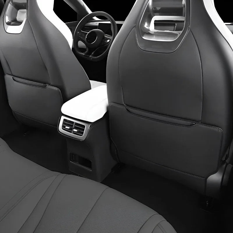 Black and white premium leather car seat covers with ergonomic design and sleek texture.