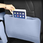 Light blue leather car seat back organizer with a tablet in the storage pocket.