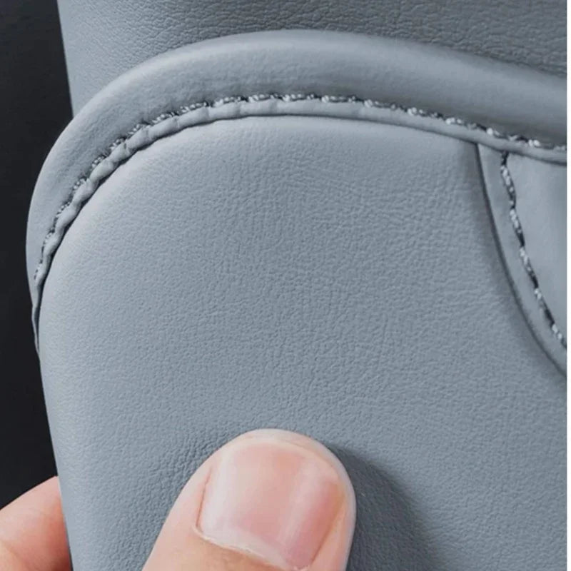 Close-up of premium grey faux leather car seat cover with durable reinforced stitching.