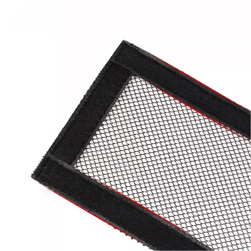 Black mesh organizer net with durable fabric borders for car interior storage.