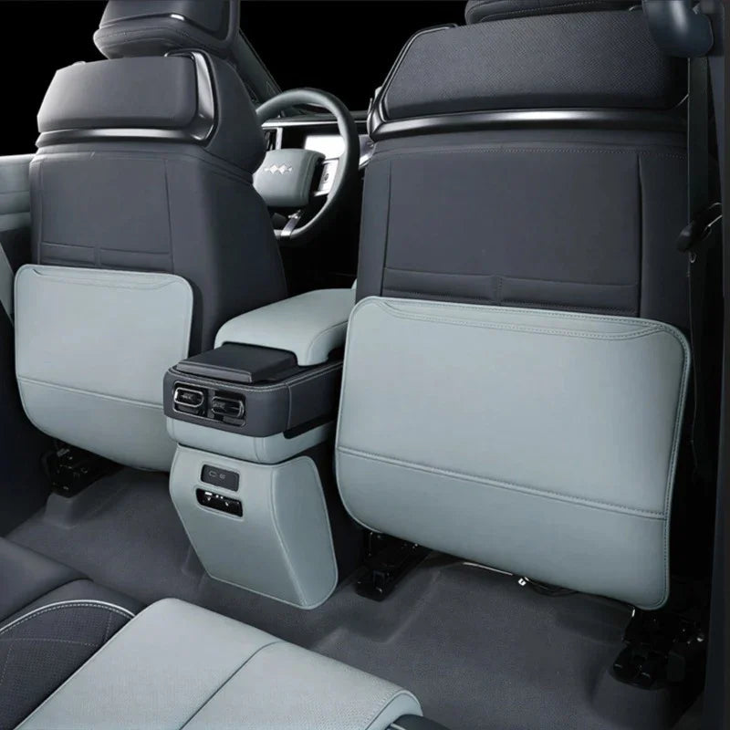 Premium light grey leather seatback protectors and center console organizer for BYD interior.