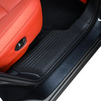Black heavy-duty rubber door sill protector installed on a car with red leather seats