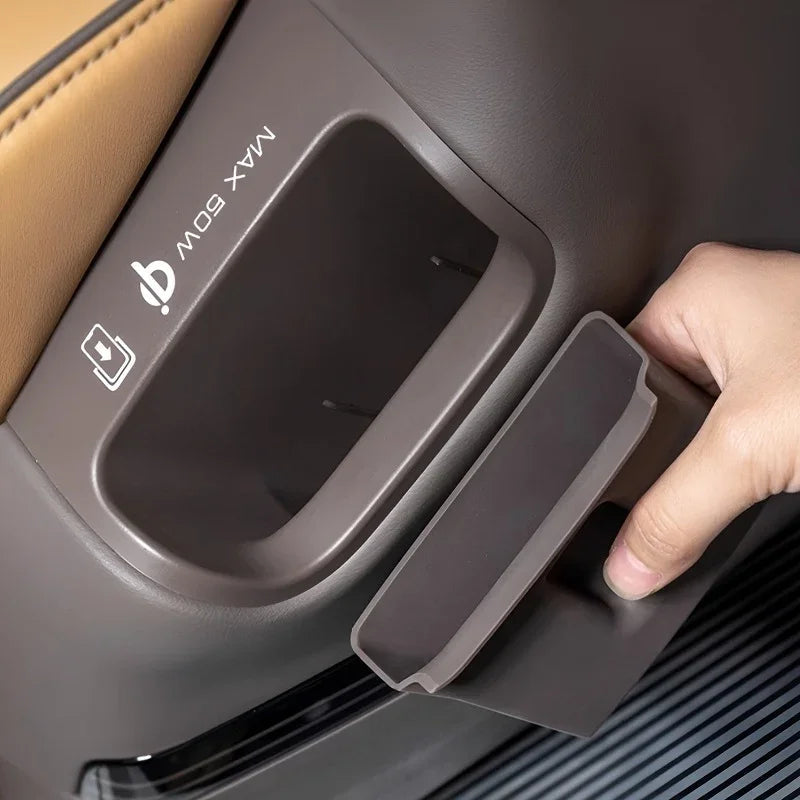 Brown silicone storage tray fitting into a car seat back pocket