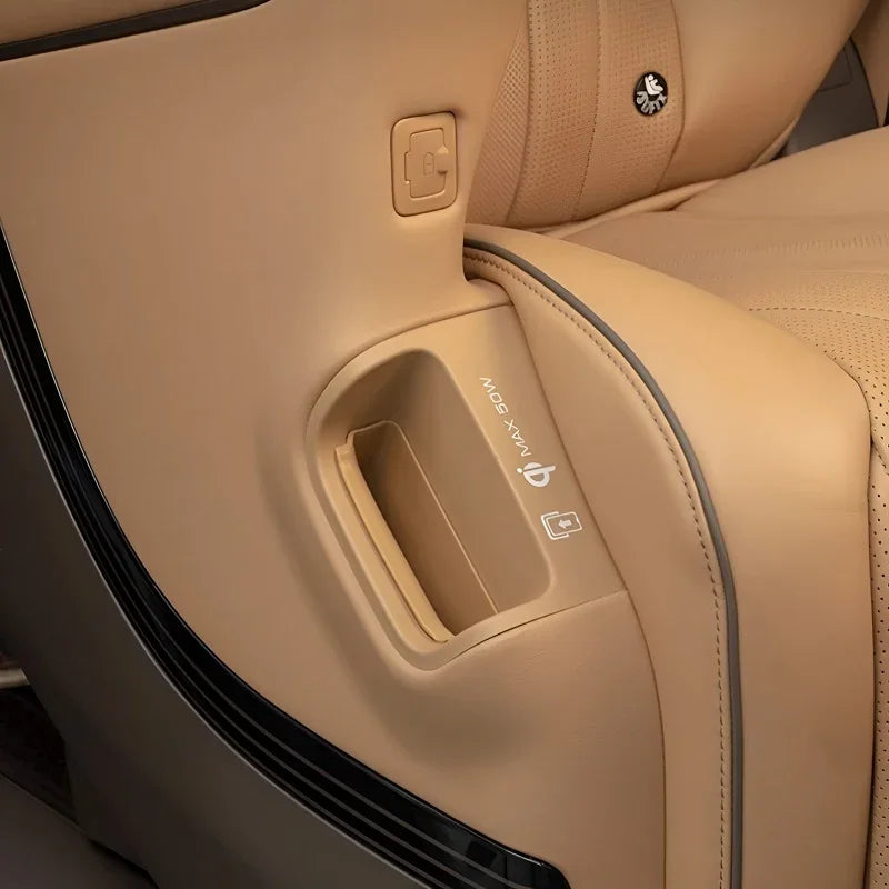Tan leather car door panel featuring a built-in storage compartment and ergonomic design.