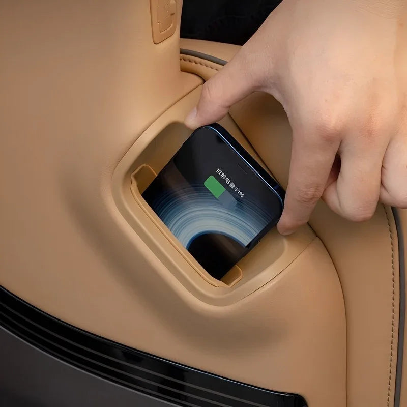 Tan leather car door pocket holding a smartphone with a sleek black finish.
