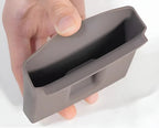 Hand holding a gray silicone car interior storage organizer tray